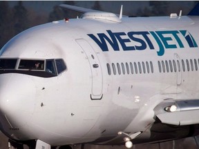 A pilot taxis a Westjet Boeing 737-700 plane to a gate after arriving at Vancouver International Airport in Richmond, B.C., on Monday February 3, 2014.