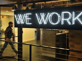 A man enter the doors of the "WeWork" co-operative co-working space on March 13, 2013 in Washington, DC. (Getty Images)