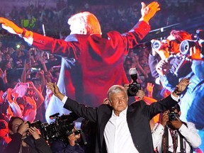 In this Wednesday, June 27, 2018 photo, presidential candidate Andres Manuel Lopez Obrador waves to supporters at his closing campaign rally in Mexico City.