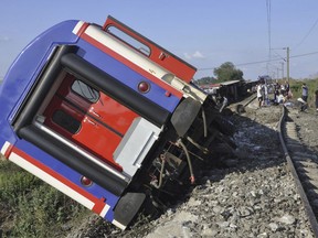 An overturned train car is seen near a village at Tekirdag province, Turkey Sunday, July 8, 2018. At least 10 people were killed and more than 70 injured Sunday when multiple cars of a train derailed in western Turkey, a Turkish official said. (AP Photo/Mehmet Yirun)