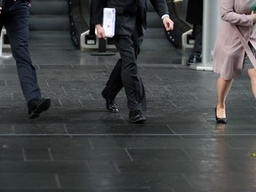 Business men and women walk in the City of London on April 4, 2018. (Daniel Leal-Olivas/Getty Images)