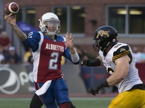 Alouettes quarterback Johnny Manziel gets rid of the ball as Hamilton Tiger-Cats' Jason Neill closes in during the first half Friday night, August 3, 2018, at Molson Stadium.