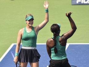 Eugenie Bouchard of Canada and Sloane Stephens salute to the fans after defeating Gabriela Dabrowski of Canada and Yifan Xu of China 4-6, 6-4, 0-1 during day one of the Rogers Cup at IGA Stadium on August 6, 2018 in Montreal, Quebec, Canada.