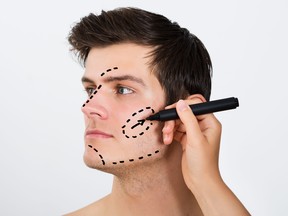 Person Hands Drawing Correction Lines On Male Face