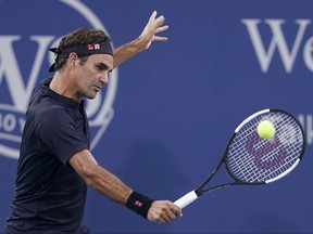 Roger Federer, of Switzerland, returns to Peter Gojowcyzk, of Germany, at the Western & Southern Open tennis tournament, Tuesday, Aug. 14, 2018, in Mason, Ohio. (AP Photo/John Minchillo)