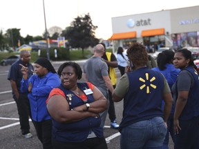 Walmart employees gather in the parking lot after a reported shooting at a Walmart in Wyncote, Pa., Tuesday, Aug. 14, 2018.  (Tim Tai/The Philadelphia Inquirer via AP)