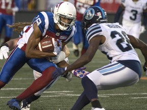 Alouettes' Adarius Bowman rushes through the defence of the Argonauts during first half CFL action in Montreal on Friday, Aug. 24, 2018.