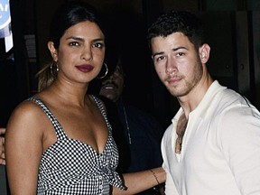 Indian Bollywood actress Priyanka Chopra and U.S. singer Nick Jonas stand together in Mumbai on June 22, 2018.