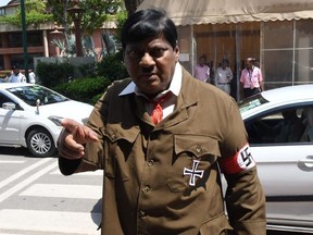 Indian film actor turned politician Naramalli Sivaprasad, arrives at parliament dressed as Adolf Hitler to press for government funding for his home state of Andhra Pradesh, in New Delhi on August 9, 2018. - Sivaprasad, 67, an icon for the low-caste Dalit community, often dresses up in outlandish costumes. In parts of Asia, Hitlers crimes are not common knowledge and he is even glorified in some places.