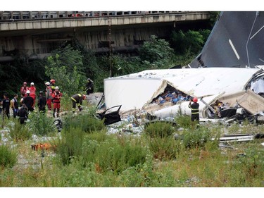 Rescuers are at work amid the rubble of a section of a giant motorway bridge that collapsed earlier, on Aug. 14, 2018 in Genoa, Italy.