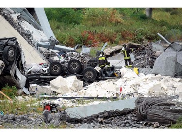 Rescuers are at work amid the rubble of a section of a giant motorway bridge that collapsed earlier, on Aug. 14, 2018 in Genoa, Italy.