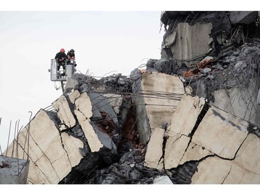 Rescuers are at work amid the rubble of a section of a giant motorway bridge that collapsed earlier, on Aug. 14, 2018 in Genoa, Italy.