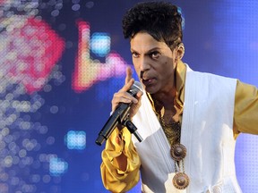This June 30, 2011 file photo shows singer and musician Prince performing on stage at the Stade de France in Saint-Denis, outside Paris. (BERTRAND GUAY/AFP/Getty Images)