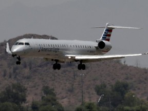 An American Eagle jet is seen through heat ripples as it lands at Sky Harbor International Airport, in Phoenix, Ariz., June 19, 2017.