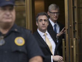 Michael Cohen, center, leaves Federal court, Tuesday, Aug. 21, 2018, in New York.