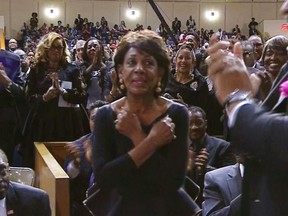 This image taken from video shows Rep. Maxine Waters, D-Calif., crossing her arms in front of her chest in the "Wakanda Forever" greeting from the film "Black Panther" as she is acknowledged at Aretha Franklin's funeral at Greater Grace Temple, Friday, Aug. 31, 2018 in Detroit. (AP Photo)