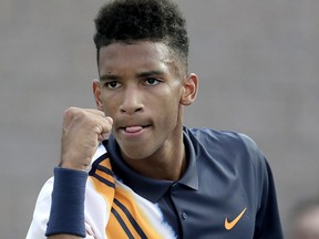 Felix Auger-Aliassime, of Canada, reacts after a point against Denis Shapovalov, also of Canada, during their first round match at the U.S. Open tennis tournament, Monday, Aug. 27, 2018, in New York. (AP Photo/Julio Cortez)