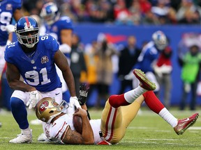 Robert Ayers of the New York Giants sacks  Colin Kaepernick of the San Francisco 49ers in the first quarter at MetLife Stadium on Nov. 16, 2014 in East Rutherford, N.J.