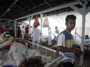 Patients are evacuated outside a hospital following an earthquake in Bali, Indonesia, Monday, Aug. 6, 2018. (AP Photo/Firdia Lisnawati)
