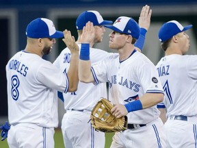 Toronto Blue Jays left fielder Billy McKinney, right, celebrates with teammate Kendrys Morales after defeating the Baltimore Orioles during ninth inning AL baseball action in Toronto on Tuesday, Aug. 21, 2018.