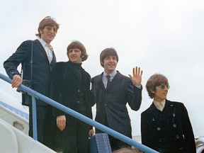 This 1966 file photo shows The Beatles, from left, John Lennon, Ringo Starr, Paul McCartney and George Harrison as they leave London Airport on their trip to the U.S. and Canada. (THE CANADIAN PRESS/AP-Files)