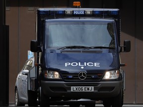 An armoured police van believed to carry Salih Khater drives out of the car park at Westminster Magistrates court in London, Monday, Aug. 20, 2018.