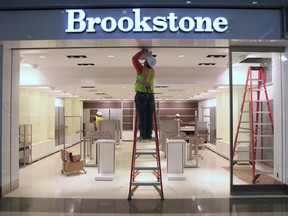 In this Sept. 12, 2011, file photo, work is done on a light fixture at the Brookstone shop at the new Terminal B at the Sacramento International Airport in Sacramento, Calif.