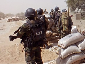 In this photo taken on Feb. 25, 2015, Cameroon soldiers stand guard at a lookout post as they take part in operations against the Islamic extremist group Boko Haram, near the village of Fotokol, Cameroon.