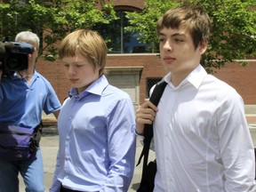 Alex Vavilov, right, and his older brother brother Tim leave a federal court after a bail hearing for their parents Donald Heathfield and Tracey Ann Foley, in Boston, Massachusetts on July 1, 2010.