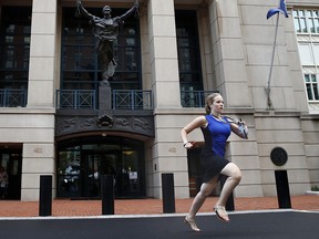 Cassie Semyon, 21, an intern for NBC News, runs from the courthouse as jury deliberations are announced in the trial of the former Donald Trump campaign chairman Paul Manafort in Alexandria, Va., Tuesday, Aug. 21, 2018. (AP Photo/Jacquelyn Martin)