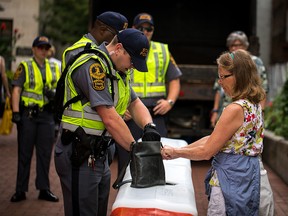Virginia State Patrol officers check bags at a checkpoint to enter a mall in Charlottesville, Virginia, on August 11, 2018. (Logan Cyrus/AFP/Getty Images)