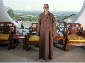 Abbot Xuecheng of the Beijing Longquan Temple poses for a photo in one of the temple buildings in Beijing, China on July 3, 2015. (Chinatopix via AP)