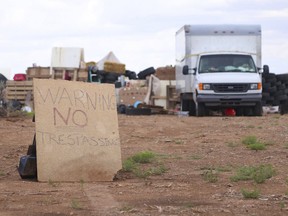 This Aug. 5, 2018 photo shows a "no trespassing" sign outside the location where people camped near Amalia, N.M.