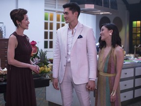 This image released by Warner Bros. Entertainment shows Michelle Yeoh, from left, Henry Golding and Constance Wu in a scene from the film "Crazy Rich Asians."