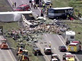 This photo from video provided by KQRENews13 shows first responders working the scene of a deadly collision between a Greyhound passenger bus and a semi-truck on Interstate 40 near the town of Thoreau, N.M., near the Arizona border, Thursday, Aug. 30, 2018.