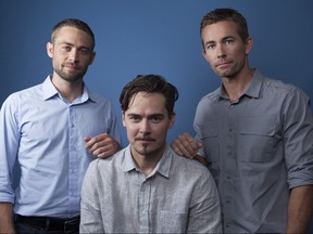 In this Wednesday, Aug. 8, 2018 photo, Cody Walker, from left, Adrian Buitenhuis and Caleb Walker, pose for a portrait in Los Angeles, in promotion of the documentary film "I Am Paul Walker." (Photo by Rebecca Cabage/Invision/AP)
