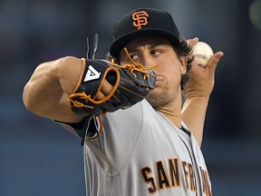 San Francisco Giants starting pitcher Derek Holland winds up during a game against the Los Angeles Dodgers on Wednesday, Aug. 15, 2018, in Los Angeles. (AP Photo/Mark J. Terrill)