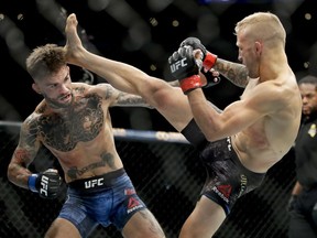 T.J. Dillashaw, right, kicks Cody Garbrandt during their UFC title bantamweight bout at UFC 227 in Los Angeles, Saturday, Aug. 4, 2018.