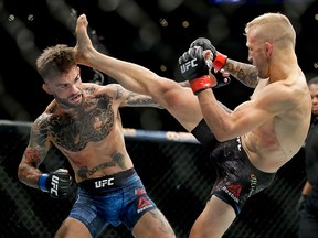 T.J. Dillashaw, right, kicks Cody Garbrandt during their UFC title bantamweight mixed martial arts bout at UFC 227 in Los Angeles, Saturday, Aug. 4, 2018.