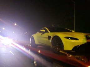 A yellow Aston Martin is hauled away after York Regional Police made a speeding arrest on Aug. 19, 2018 in Vaughan.