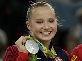 United States' Madison Kocian, displays her silver medal for the uneven bars during the artistic gymnastics women's apparatus final at the 2016 Summer Olympics in Rio de Janeiro, Brazil, on Aug. 14, 2016.