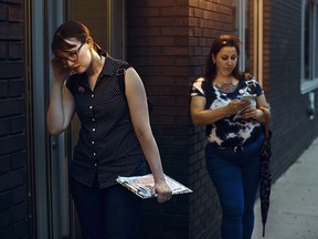 Democratic socialist activist, Leslie Jones, left, knocks on doors with an escort who goes by the name Lana Marciano, right, as they canvass for Julia Salazar, who is running for the Democratic primary of the 18th district seat of the New York State Senate on Aug. 19, 2018, in the Brooklyn borough of New York. (AP Photo/Andres Kudacki)