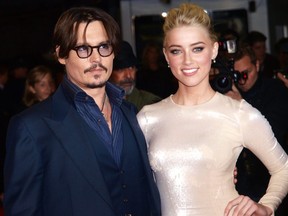 Johnny Depp and actress Amber Heard pose as they arrive for the European premiere of their film 'The Rum Diary' in Kensington district in London on Nov. 3, 2011.