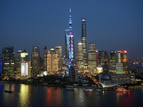 Ships pass by the skyline of the Lujiazui Financial District in Pudong in Shanghai on August 14, 2015.