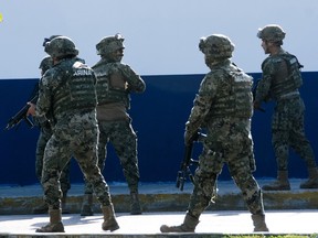 Mexican marines arrive at the place where a shooting erupted after an attack against the building of the Quintana Roo State Prosecution, in Cancun, Mexico, on January 17, 2017.