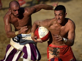 Players compete during the final match of the Calcio Storico Fiorentino traditional 16th Century Renaissance ball game, on Piazza Santa Croce in Florence on June 24, 2017. (Filippo Monteforte/Getty Images)