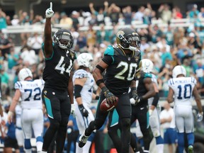 Jalen Ramsey #20 and Myles Jack #44 of the Jacksonville Jaguars celebrate after Ramsey had  an interception in the first half of their game against the Indianapolis Colts at EverBank Field on December 3, 2017 in Jacksonville, Florida.