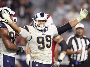 Defensive end Aaron Donald #99 of the Los Angeles Rams reacts after a tackle against the Arizona Cardinals during the second half at the University of Phoenix Stadium on December 3, 2017 in Glendale, Arizona.