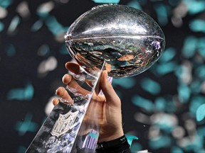 Quarterback Nick Foles of the Philadelphia Eagles raises the Vince Lombardi Trophy after defeating the New England Patriots, 41-33, in Super Bowl LII at U.S. Bank Stadium on February 4, 2018 in Minneapolis, Minnesota.
