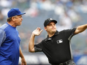 First base umpire Jansen Visconti throws Toronto Blue Jays manager John Gibbons out of the game against the New York Yankees in the sixth inning in New York, on Sunday.